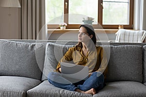 Young attractive serious thoughtful woman do creative telework on computer