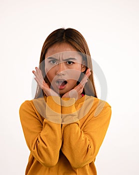 Young attractive shocked asian girl in studio