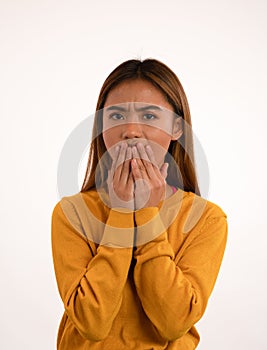 Young attractive shocked asian girl in studio