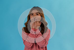 Young attractive shocked asian girl in studio