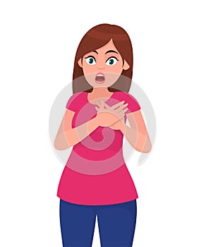 Young attractive shocked woman holds hands on chest. Sick woman with heart attack, pain, health problem holding touching her chest