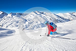 Young attractive skier skiing in famous ski resort in Alps, Livigno, Italy, Europe