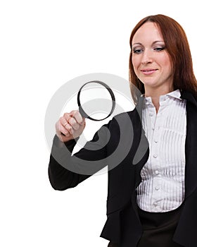 Young attractive smiling business woman looking into a magnifying glass, isolated on white