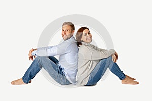 Young attractive smiling couple thinking of future or past together on white and copy space