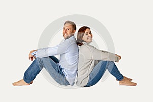 Young attractive smiling couple thinking of future or past together on white and copy space