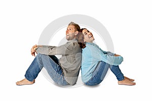 Young attractive smiling couple thinking of future or past together on white and copy space