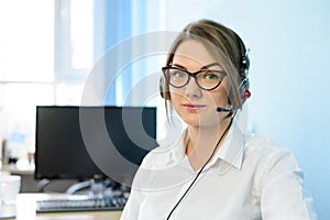 Young Attractive Smiling Customer Support Phone Operator with Headset in Office.