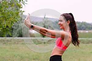 Young attractive smiling toned brunette woman doing selfie while working out Healthy lifestyle concept