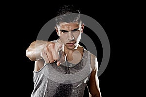 Young attractive sport man big strong athletic body pointing in join my fitness club gym concept