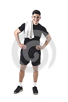 Young attractive sport man with fit strong body holding towel on his shoulder smiling happy