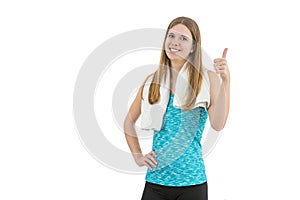 Young attractive sportswoman giving thumbs up