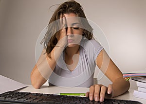 Young attractive student girl or working woman sitting at computer desk in stress looking tired exhausted and boring