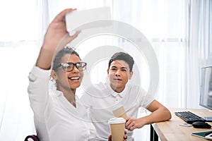 young attractive students taking selfie with cups