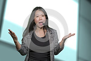 Young attractive and successful Asian Chinese woman in microphone headset coaching and training business strategies talking in