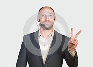 Young attractive and successful businessman smiling happy and confident  white background giving victory fingers sign
