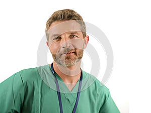 Young attractive and successful medicine doctor or nurse man posing confident smiling happy in green medical uniform standing