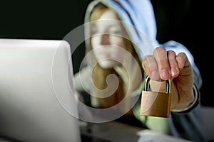 young attractive teen woman wearing hoodie hacking laptop cybercrime cyber crime concept