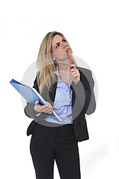 Young attractive and thoughtful business woman with blue folder and pen thinking about project