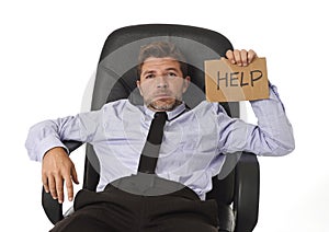 Young attractive tired and wasted businessman sitting on office chair asking for help in stress