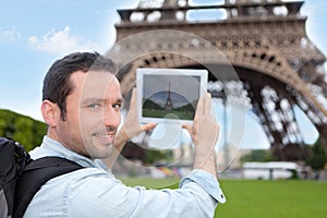 Young attractive tourist taking picture in Paris