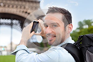 Young attractive tourist taking picture in Paris