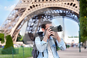 Young attractive tourist taking pictures in Paris