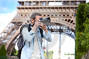 Young attractive tourist taking pictures in Paris