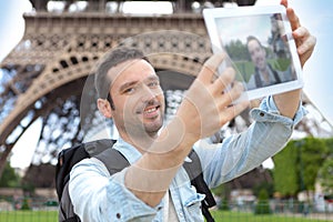 Young attractive tourist taking selfie in Paris