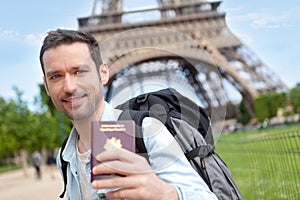 Young attractive traveler in Paris with passport