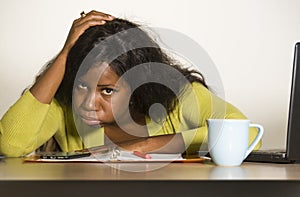 Young attractive unhappy and exhausted black African American woman working lazy on Monday at office computer desk feeling overwhe