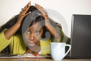 Young attractive unhappy and exhausted black African American woman working lazy on Monday at office computer desk feeling overwhe