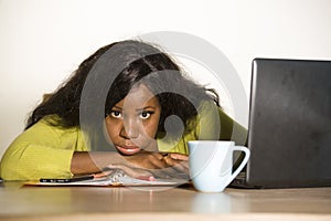 Young attractive unhappy and exhausted black African American woman working lazy on Monday at office computer desk feeling overwhe