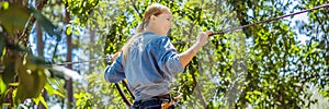 Young attractive woman in adventure rope park in safety equipment BANNER, LONG FORMAT