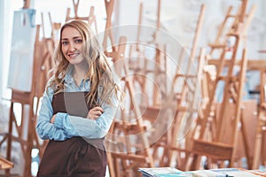 Young attractive woman on the background of easels