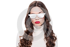 young attractive woman with bright makeup wearing white sunglasses and raising brow,
