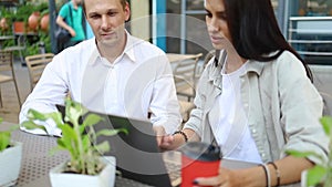 Young attractive woman at business meeting with friends laughing talk sitting in outdoor cafe. slow motion close up