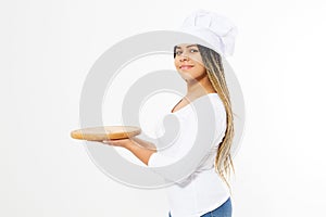 Young attractive woman in cooking hat holding empty tray isolated on white background. Copy space and mock up. Blank template