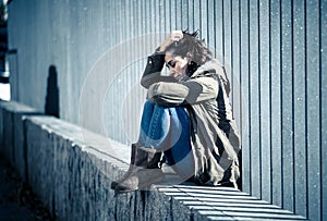 Young attractive woman crying suffering from depression sitting