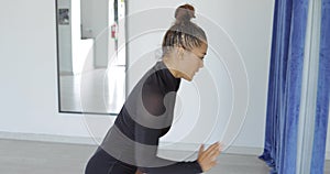 Young attractive woman dancing in studio