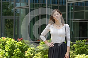 Young attractive woman in dress. Business park. City park. Concept photo