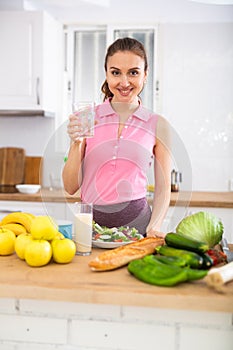 Young attractive woman drinking water at home