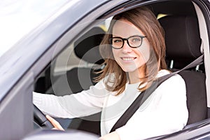 Young attractive woman driving his car