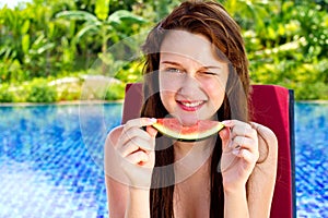 An young and attractive woman eating watermelon by