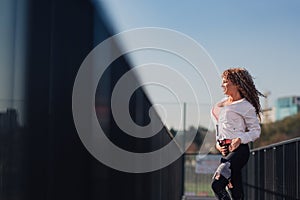 Young attractive woman enjoying outdoor physical exercise in the city