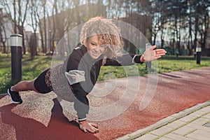 Young attractive woman enjoying outdoor physical exercise in the city