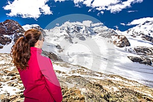 Young attractive woman enjoying the stunning view of Morteratsch glacier from Diavolezza mountain, canton G