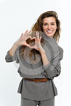 A young attractive woman folded her palms in the shape of a heart