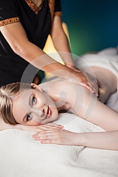 Young attractive woman getting massaging treatment at hospital