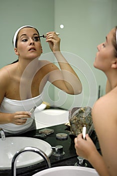 Young attractive woman getting ready in bathroom