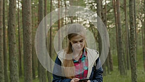 Young attractive woman hiking in a forest